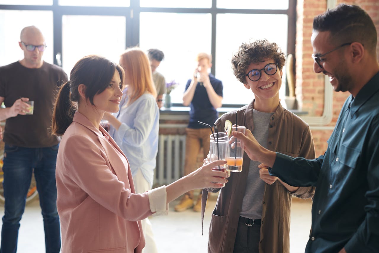 who-we-are-img Group of diverse office colleagues enjoying drinks and a casual conversation in a bright workspace.