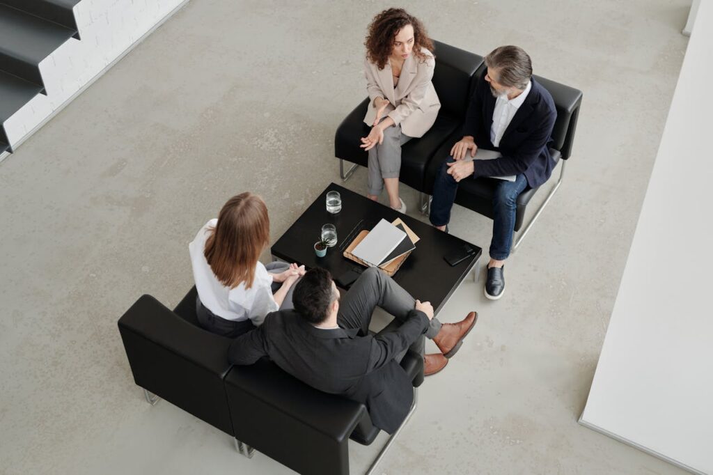 pexels photo 4343028 1 A group of professionals engaged in a collaborative business meeting in a modern office setting.