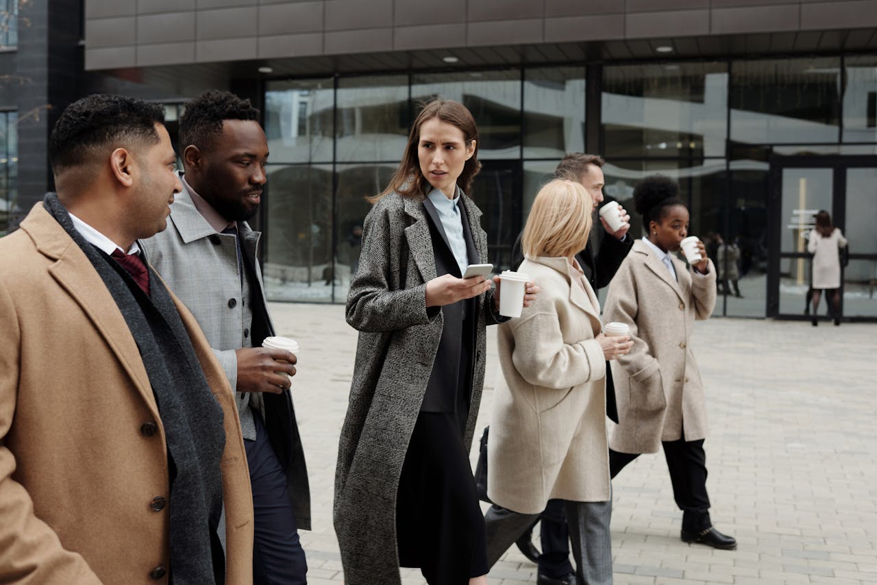 services-04 A group of diverse business professionals enjoying a coffee break outdoors in the city.