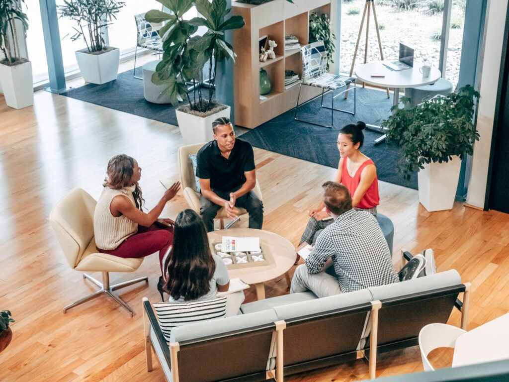 pexels photo 7688173 A diverse group of professionals engage in a collaborative team meeting in a stylish office environment.